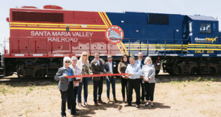 State and local partners join OmniTRAX officials to commemorate the new joint venture partnership operating the Santa Maria Valley Railroad. Left to Right: Alice Patino (Mayor of Santa Maria, Calf.), Vicki Conner (EconAlliance, Initiatives Director), Suzanne Singh (Santa Maria Chamber of Commerce, VP of Economic Development and Government Affairs), Dean Piacente (OmniTRAX, CEO), Scott Remington (OmniTRAX, Vice President, Corporate Development), Belinda Popovich (Santa Maria Valley Railroad, Assistant General Manager), Rob Himoto (Santa Maria Valley Railroad, President), Bob Nelson (County of Santa Barbara, Fourth District Supervisor), and Jenelle Osborne (EconAlliance, CEO). (Photograph Courtesy of OmniTrax)